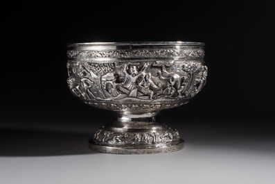 A large repouss&eacute; silver footed bowl depicting a hunting scene, India, late 19/early 20th C.