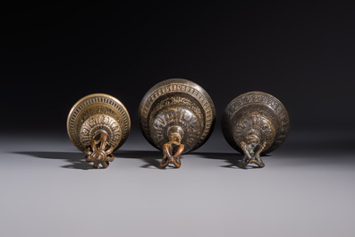 Three Tibetan bronze ritual bells and a bronze Buddha, 19th C.