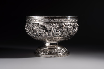 A large repouss&eacute; silver footed bowl depicting a hunting scene, India, late 19/early 20th C.