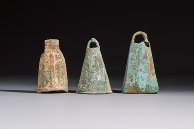 Seven various Chinese bronze and cast-iron bells, Han and later