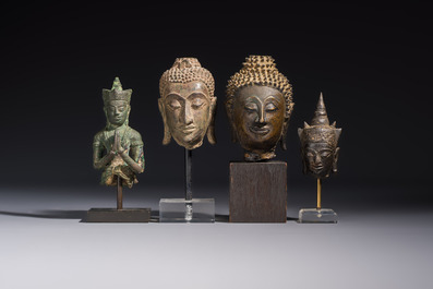 A bronze standing Buddha, a torso of Buddha and four heads of Buddha, Thailand, 17/18th C.
