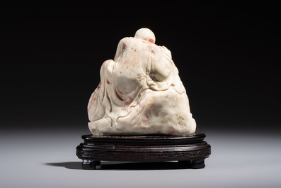 A Chinese carved soapstone 'Luohan' group on a wooden stand, Republic