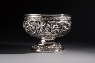 A large repouss&eacute; silver footed bowl depicting a hunting scene, India, late 19/early 20th C.
