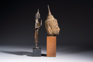 A bronze standing Buddha, a torso of Buddha and four heads of Buddha, Thailand, 17/18th C.