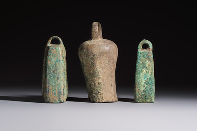 Seven various Chinese bronze and cast-iron bells, Han and later