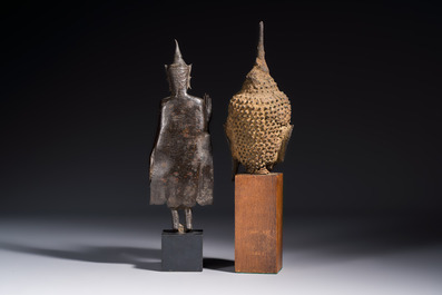 A bronze standing Buddha, a torso of Buddha and four heads of Buddha, Thailand, 17/18th C.