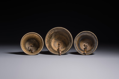 Three Tibetan bronze ritual bells and a bronze Buddha, 19th C.