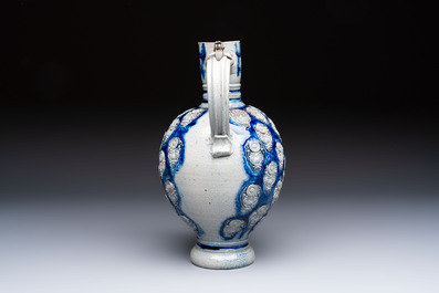 A Westerwald stoneware jug with a lion's head and moulded floral design, Germany, 17th C.