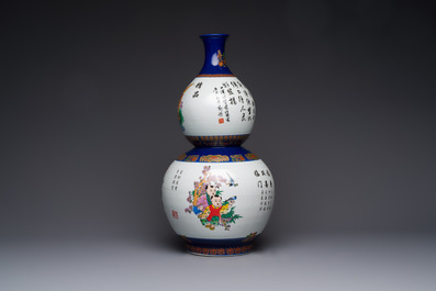 A large Chinese polychrome-decorated blue-ground double-gourd vase, 20th C.