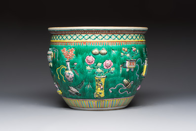 A Chinese famille rose green-ground 'Antiquities' fish bowl or jardini&egrave;re with applied relief design, 19th C.