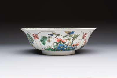 A Chinese famille verte bowl with bird and butterflies among flowers, lozenge mark, Kangxi