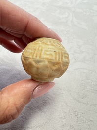 A pair of Chinese bird feeders with moulded design, one unglazed, on later wooden stands, Song