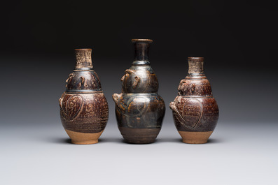 Three khmer-style brown-glazed anthropomorphic gourd-form bottles, probably 12/13th C.
