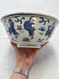 A Chinese blue and white 'Eight Immortals' bowl on a wooden stand, Chenghua mark, late Ming