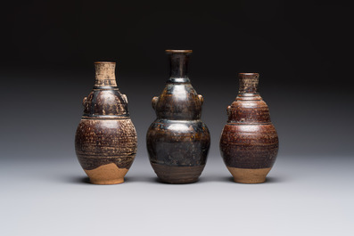 Three khmer-style brown-glazed anthropomorphic gourd-form bottles, probably 12/13th C.