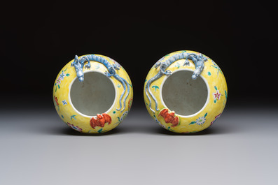 A pair of Chinese famille rose yellow-ground water pots with floral design and applied chilong and bats, Qianlong mark, 19/20th C.