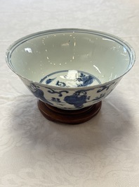 A Chinese blue and white 'Eight Immortals' bowl on a wooden stand, Chenghua mark, late Ming