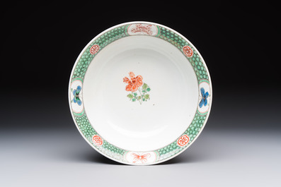A Chinese famille verte bowl with bird and butterflies among flowers, lozenge mark, Kangxi