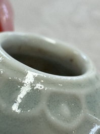 A pair of Chinese bird feeders with moulded design, one unglazed, on later wooden stands, Song
