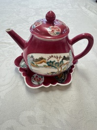 A Chinese famille rose ruby-ground 'Landscape Scroll' teapot and stand, Yongzheng
