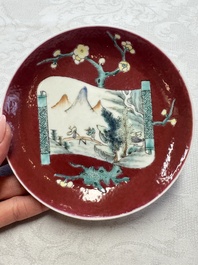 Two Chinese famille rose ruby-ground 'Landscape Scroll' cups and saucers, Yongzheng