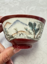 Two Chinese famille rose ruby-ground 'Landscape Scroll' cups and saucers, Yongzheng