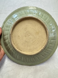 An unusual Chinese blue and white celadon-back 'Buddhist Lion' plate, Ming