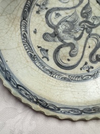 An unusual Chinese blue and white celadon-back 'Buddhist Lion' plate, Ming