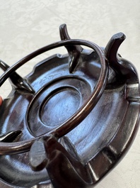 A Chinese famille rose 'Birds and Insects among Flowers' teapot on a later wooden stand, Yongzheng