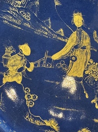 A Chinese gilt-decorated powder-blue-ground 'Elegant Beauty and Boy' dish, Kangxi