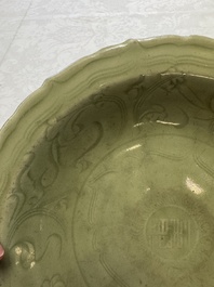 A Chinese Longquan celadon inscribed dish with incised floral design, Ming