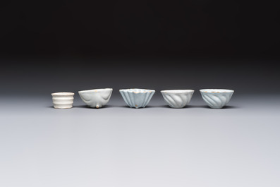 A collection of nine white-glazed Dutch Delft pudding moulds, a mustard pot and a two-handled strainer, 18th C.