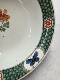 A Chinese famille verte bowl with bird and butterflies among flowers, lozenge mark, Kangxi