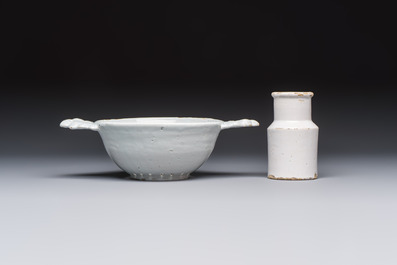 A collection of nine white-glazed Dutch Delft pudding moulds, a mustard pot and a two-handled strainer, 18th C.