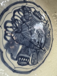 A Chinese blue and white plate with a relief-moulded rim, Wanli
