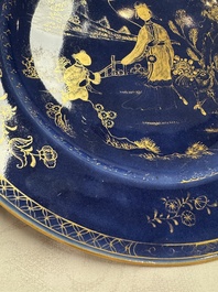 A Chinese gilt-decorated powder-blue-ground 'Elegant Beauty and Boy' dish, Kangxi