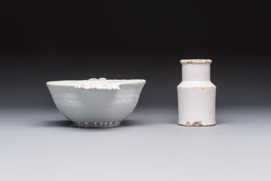 A collection of nine white-glazed Dutch Delft pudding moulds, a mustard pot and a two-handled strainer, 18th C.