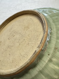 An unusual Chinese blue and white celadon-back 'Buddhist Lion' plate, Ming