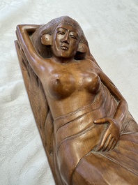 A Balinese carved wooden sculpture of a reclining lady, first half 20th C.