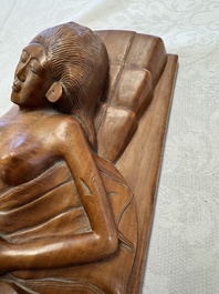 A Balinese carved wooden sculpture of a reclining lady, first half 20th C.