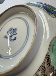 A Chinese famille verte bowl with bird and butterflies among flowers, lozenge mark, Kangxi