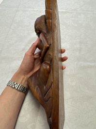 A Balinese carved wooden sculpture of a reclining lady, first half 20th C.