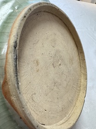 An unusual Chinese blue and white celadon-back 'Buddhist Lion' plate, Ming