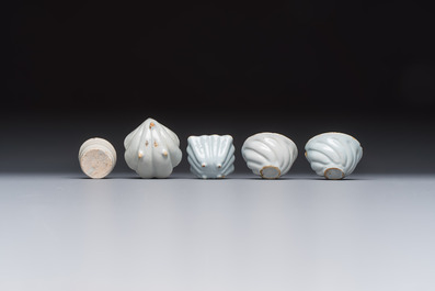 A collection of nine white-glazed Dutch Delft pudding moulds, a mustard pot and a two-handled strainer, 18th C.