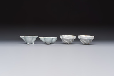 A collection of nine white-glazed Dutch Delft pudding moulds, a mustard pot and a two-handled strainer, 18th C.