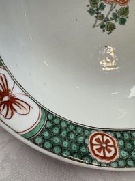 A Chinese famille verte bowl with bird and butterflies among flowers, lozenge mark, Kangxi
