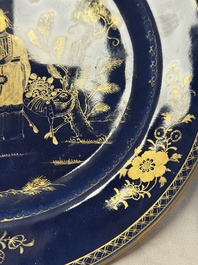 A Chinese gilt-decorated powder-blue-ground 'Elegant Beauty and Boy' dish, Kangxi