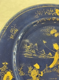 A Chinese gilt-decorated powder-blue-ground 'Elegant Beauty and Boy' dish, Kangxi