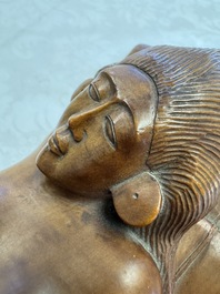 A Balinese carved wooden sculpture of a reclining lady, first half 20th C.