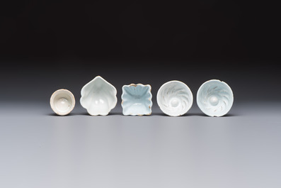 A collection of nine white-glazed Dutch Delft pudding moulds, a mustard pot and a two-handled strainer, 18th C.